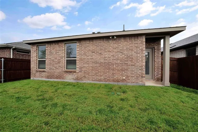a brick house with a small yard