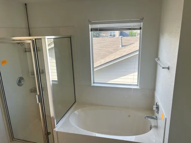 a bathroom with a bathtub and a shower