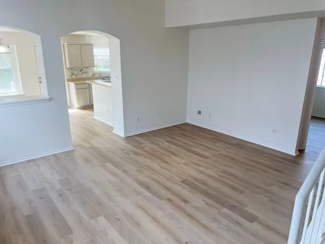 wooden floor in an empty room with a window