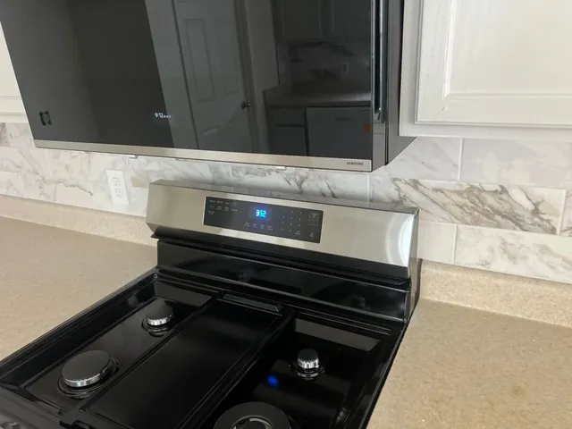 a kitchen with a stove and a microwave oven