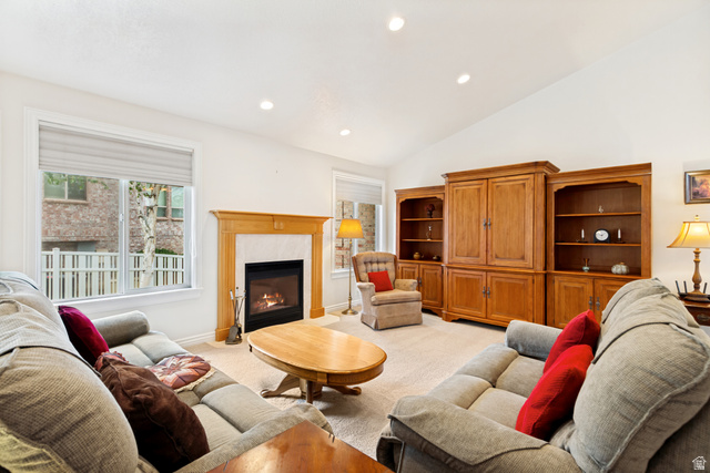298 North Canyon Road Bountiful, UT 84010 - Photo 12 of 57 Spacious living area featuring a fireplace with a light wood mantel, vaulted ceilings, recessed lighting, and large windows