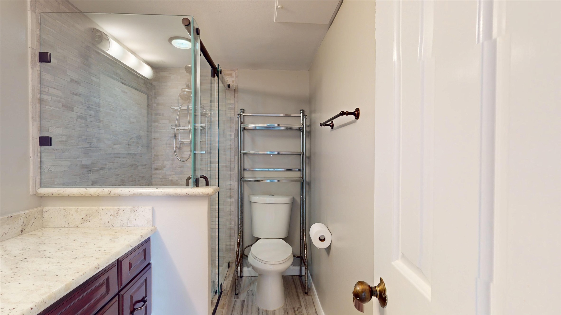 3525 Sage Road, Unit 1404 Houston, TX 77056 - Photo 16 of 36 a bathroom with a granite countertop sink toilet and shower