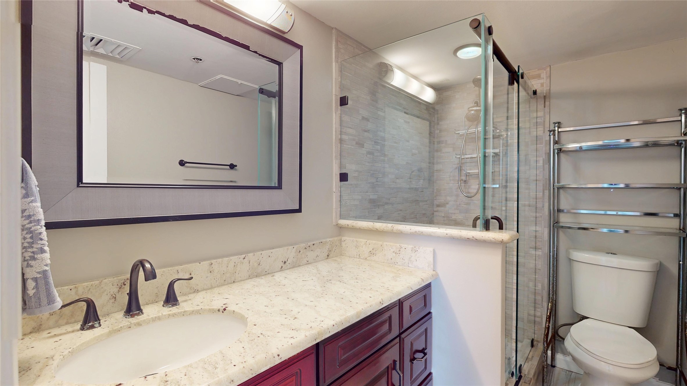 3525 Sage Road, Unit 1404 Houston, TX 77056 - Photo 17 of 36 a bathroom with a granite countertop sink toilet and shower