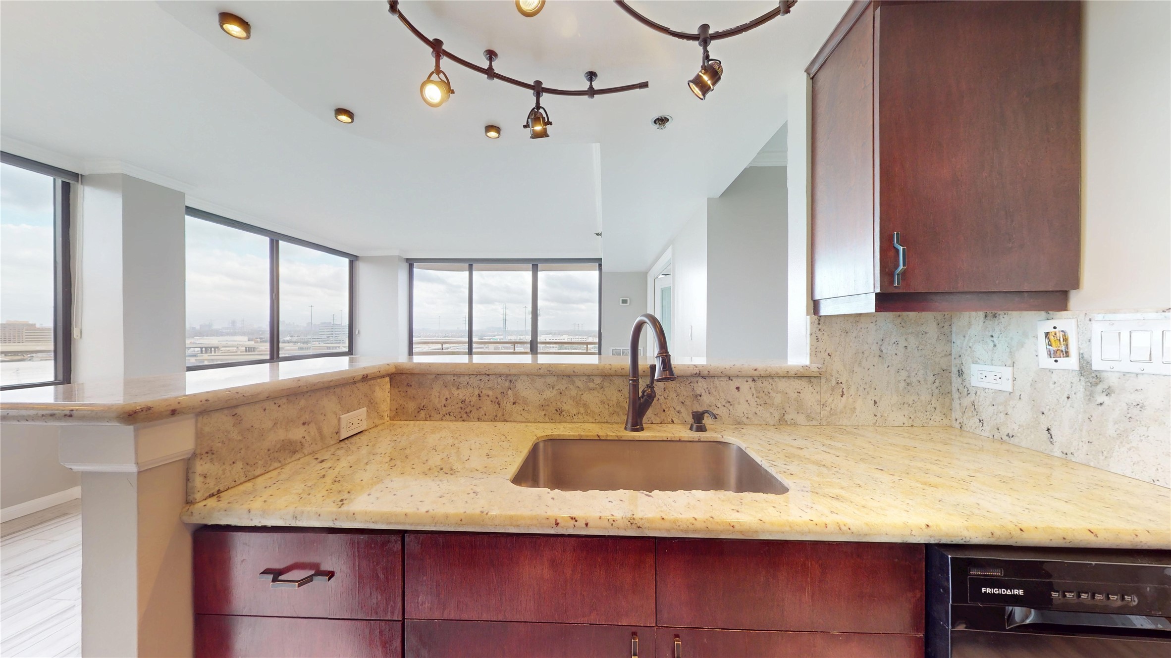 3525 Sage Road, Unit 1404 Houston, TX 77056 - Photo 19 of 36 a kitchen with kitchen island granite countertop a sink window and cabinets