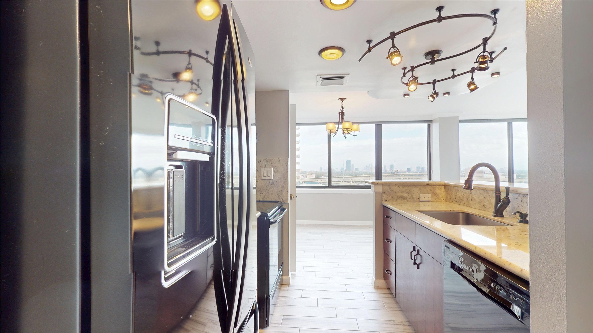 3525 Sage Road, Unit 1404 Houston, TX 77056 - Photo 21 of 36 a kitchen with stainless steel appliances granite countertop a sink and a refrigerator