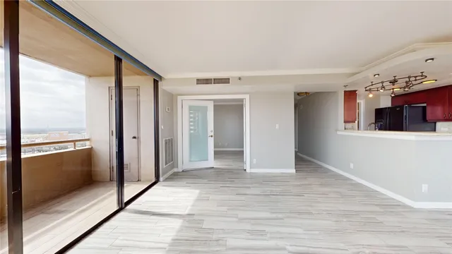 a view of a hallway with wooden floor and staircase