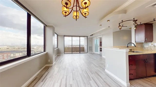 a view of a kitchen with a sink and wooden floor