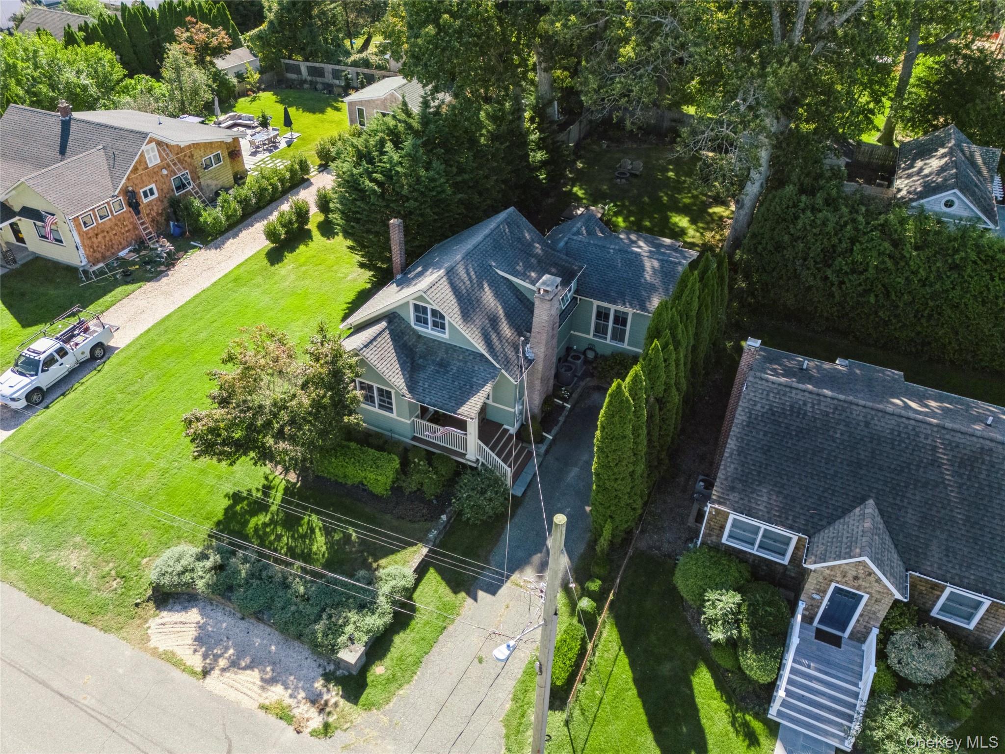 Aerial view of residential area featuring a tree filled landscape