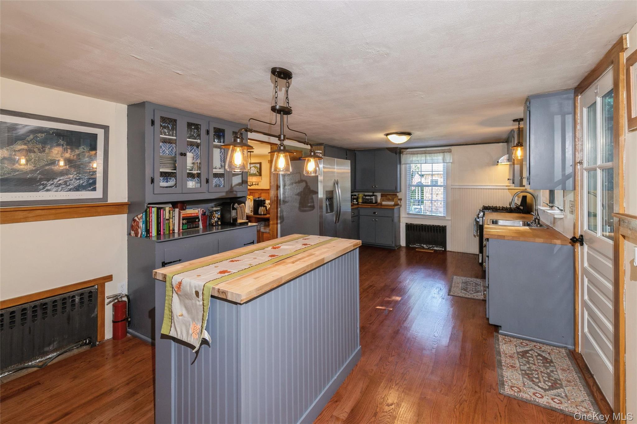 240 Wicks Road New Suffolk, NY 11956 - Photo 12 of 36 a kitchen with stainless steel appliances granite countertop wooden floors and sink