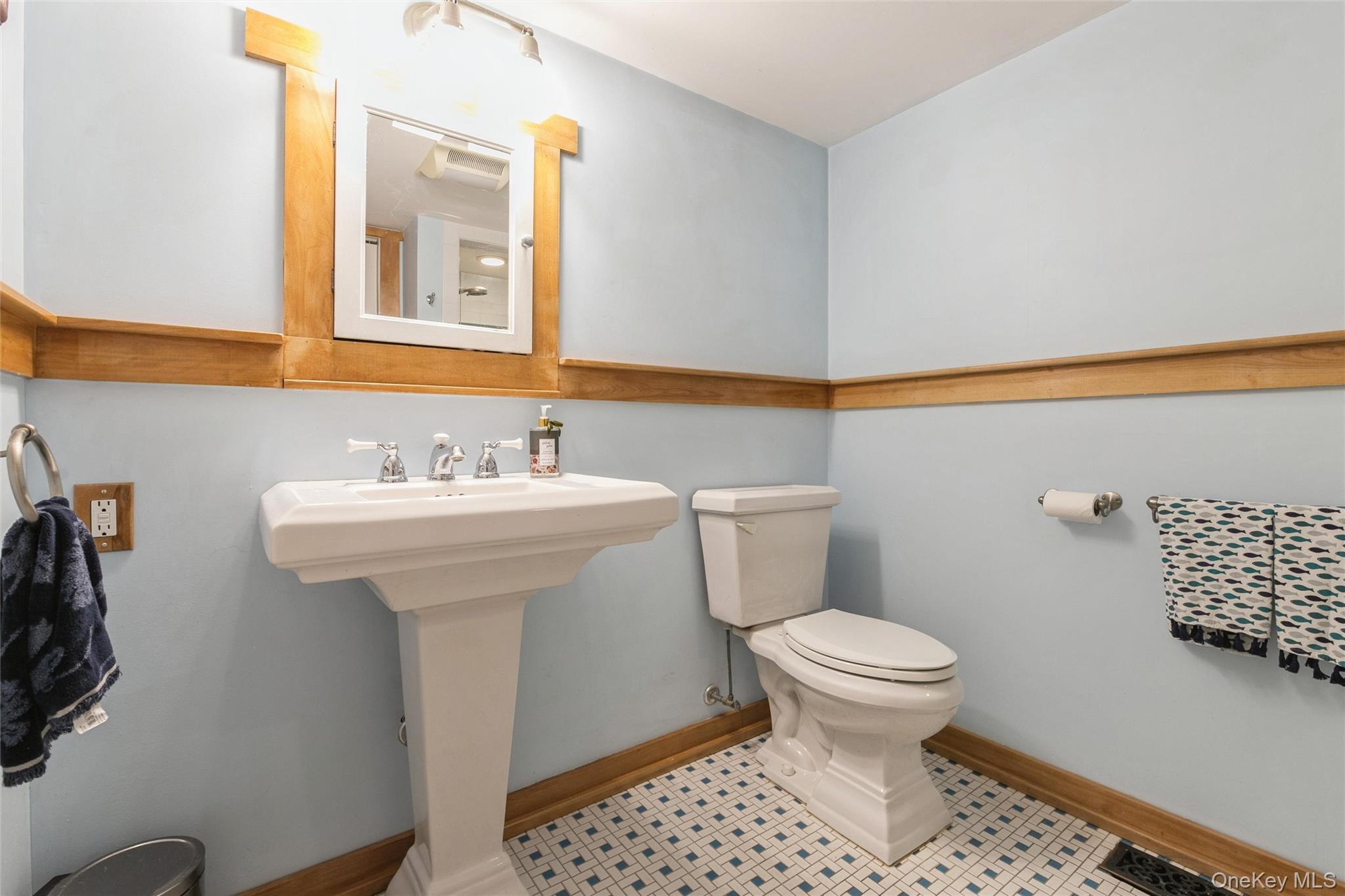 240 Wicks Road New Suffolk, NY 11956 - Photo 14 of 36 a bathroom with a sink toilet and a mirror