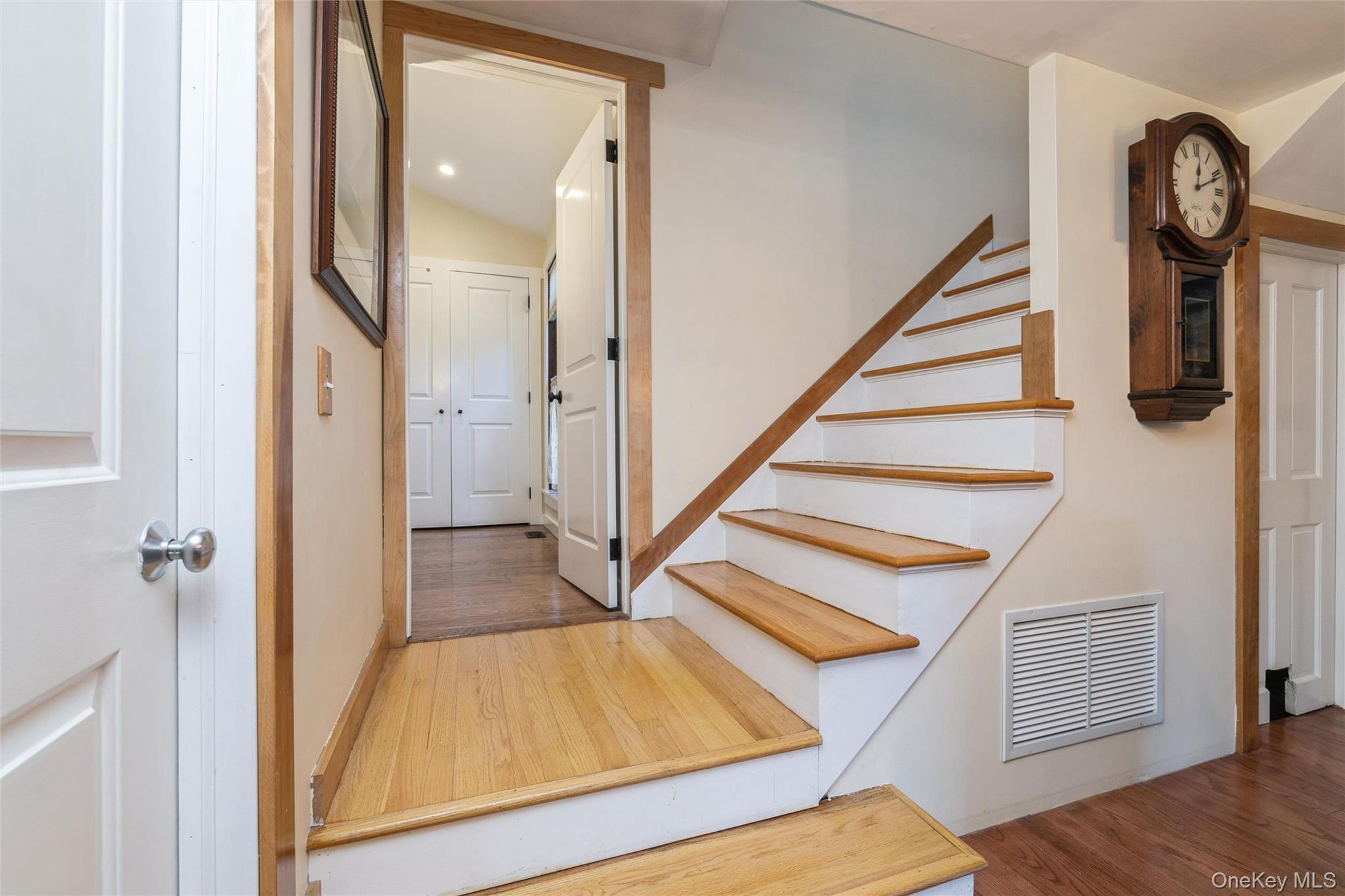 240 Wicks Road New Suffolk, NY 11956 - Photo 15 of 36 a view of staircase with wooden floor and white walls