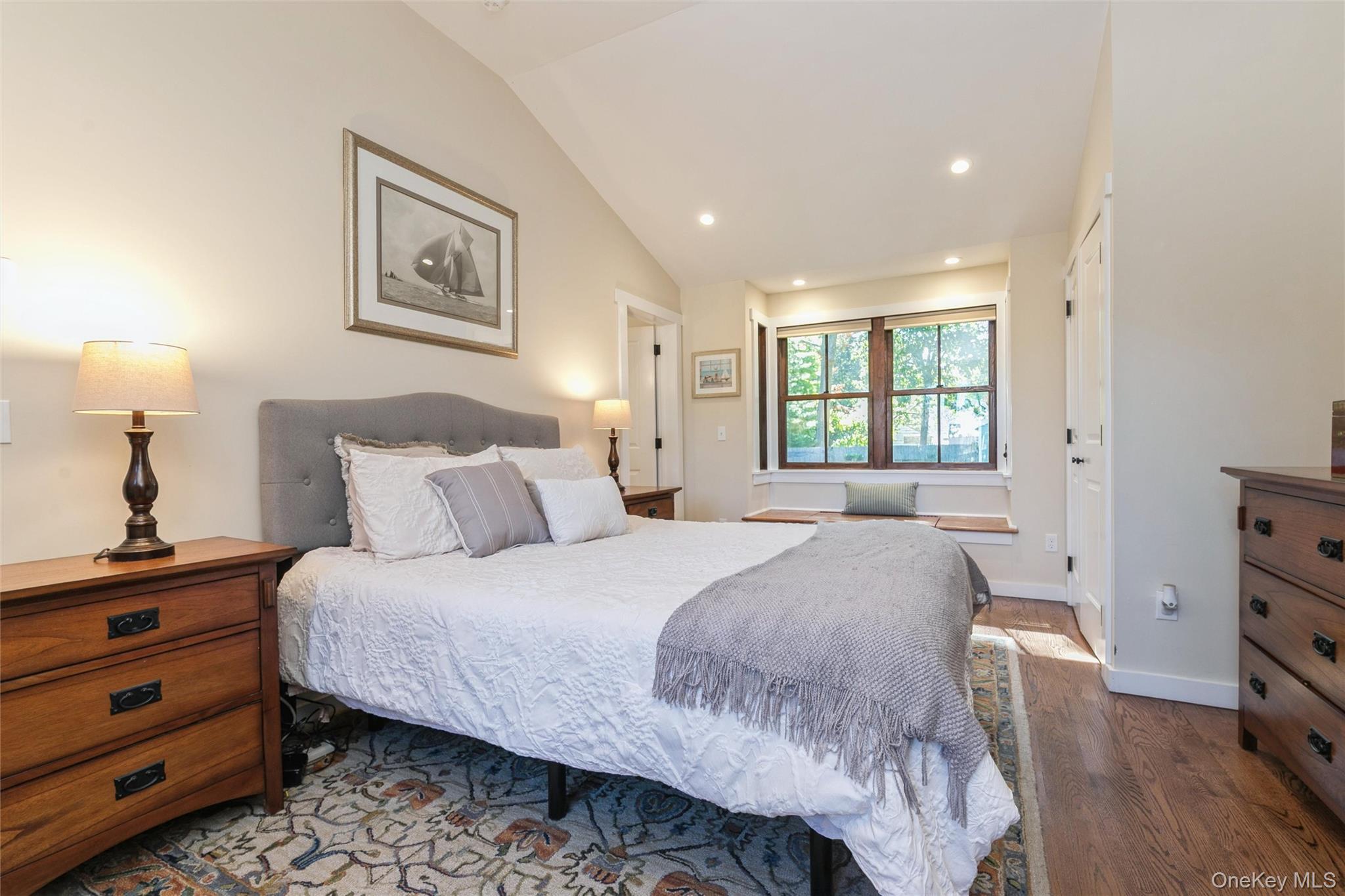 240 Wicks Road New Suffolk, NY 11956 - Photo 16 of 36 a bedroom with a bed and a dresser