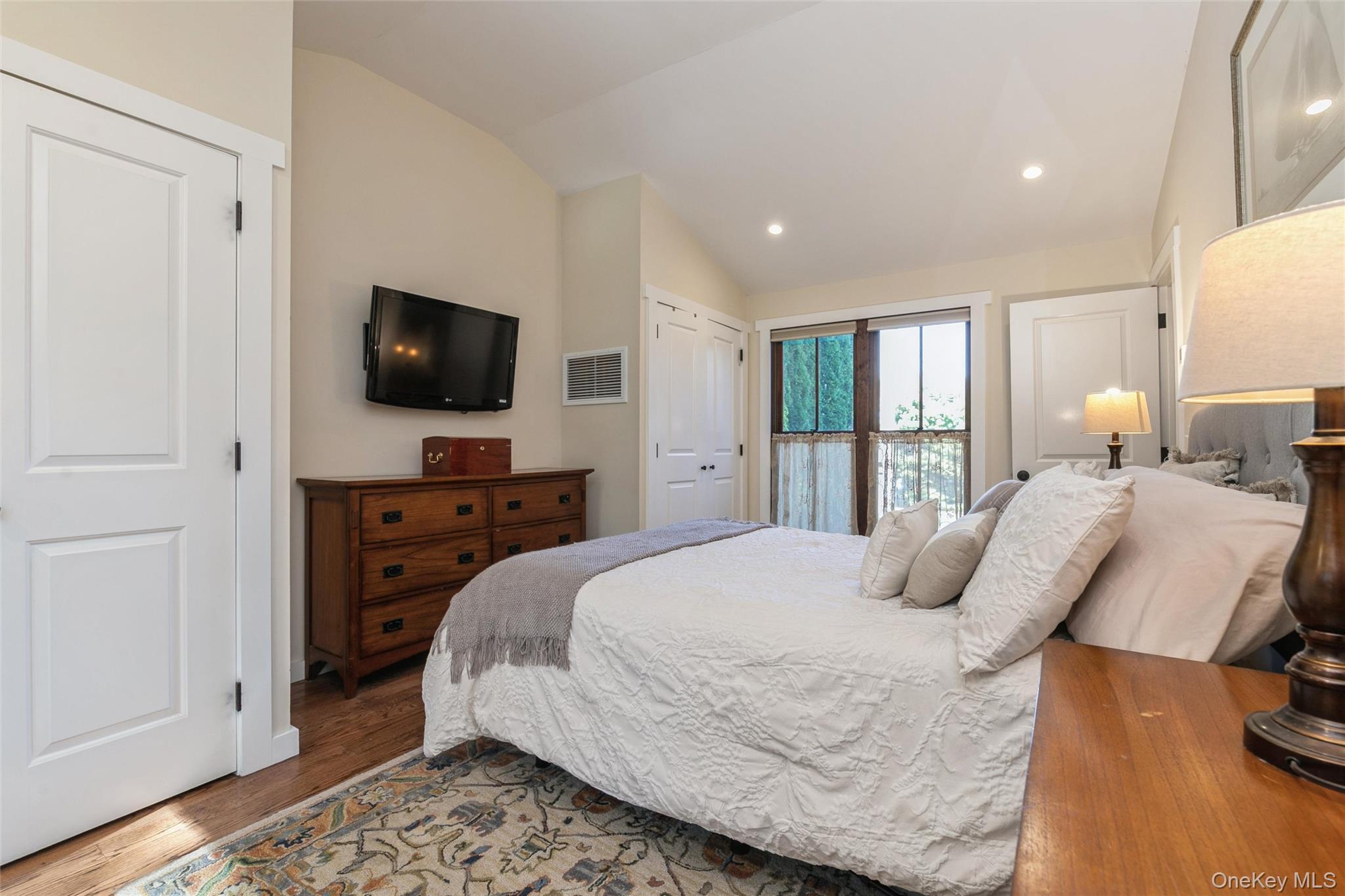 240 Wicks Road New Suffolk, NY 11956 - Photo 18 of 36 a bedroom with a bed and a television