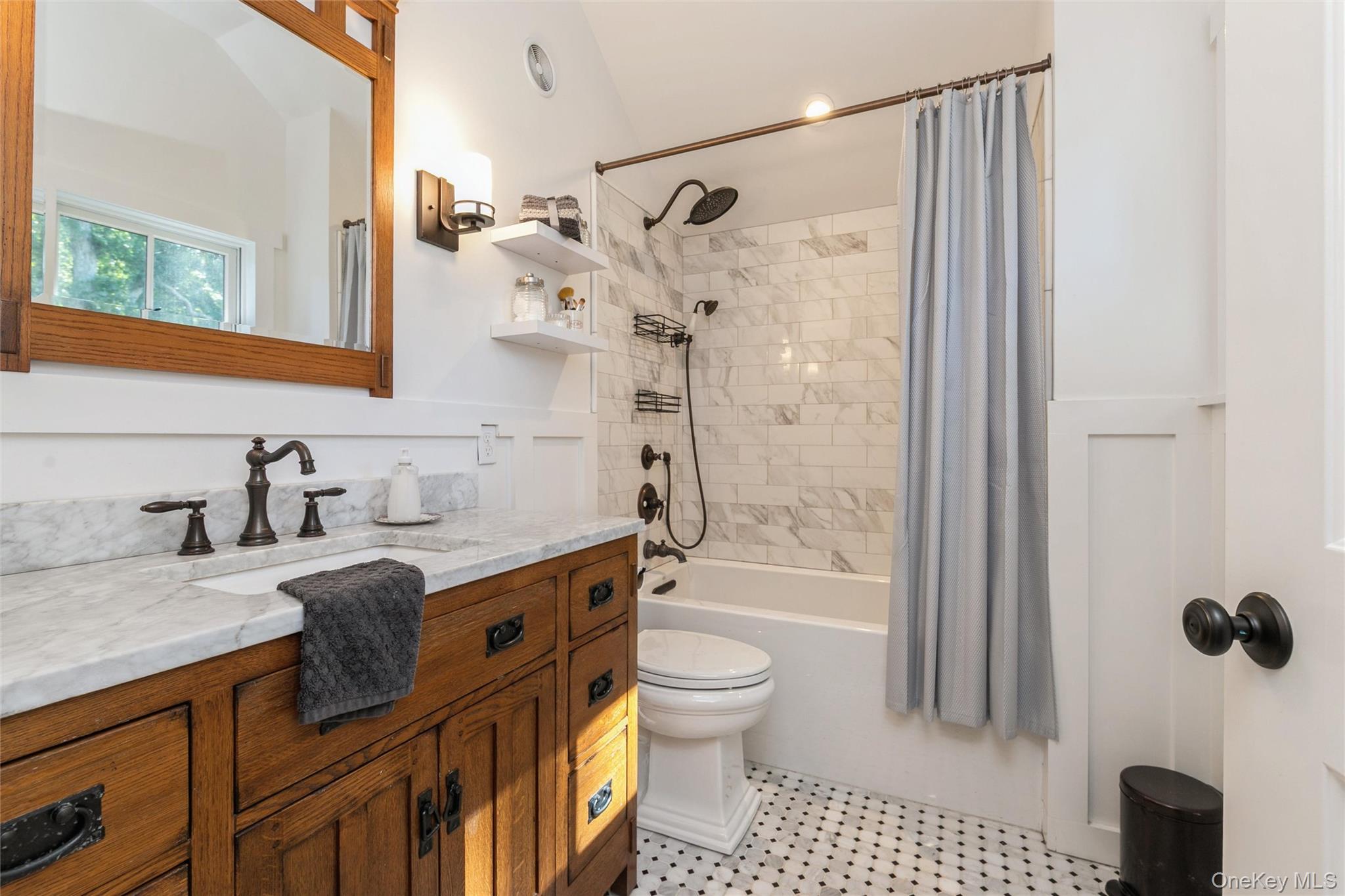 240 Wicks Road New Suffolk, NY 11956 - Photo 19 of 36 a bathroom with a granite countertop sink a toilet a mirror a glass door a shower and vanity