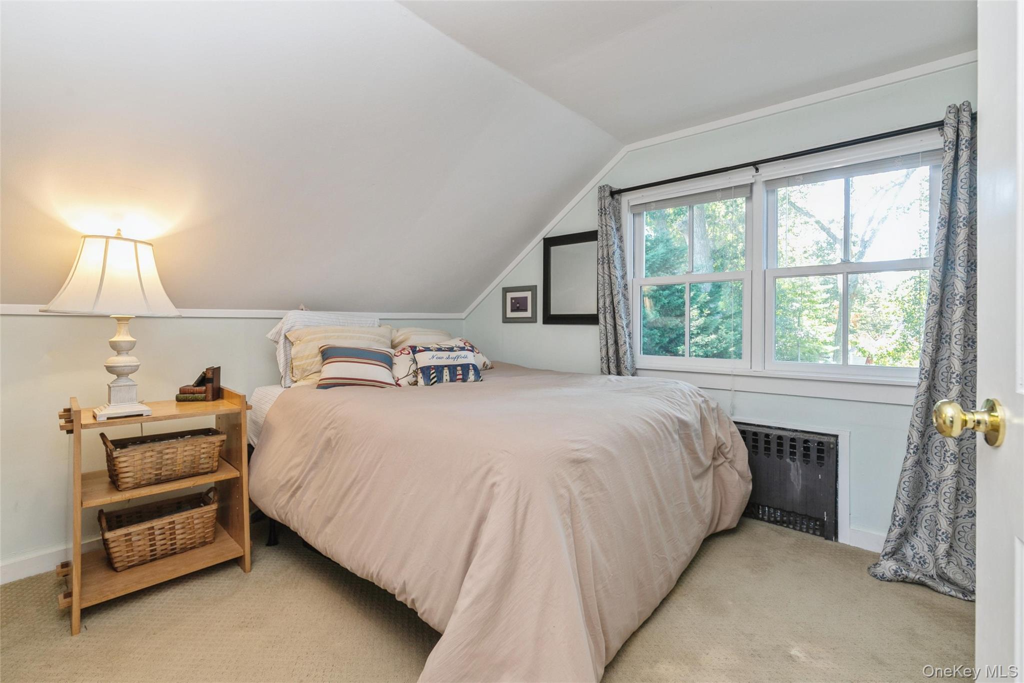 240 Wicks Road New Suffolk, NY 11956 - Photo 23 of 36 a bed sitting in a bedroom next to a window