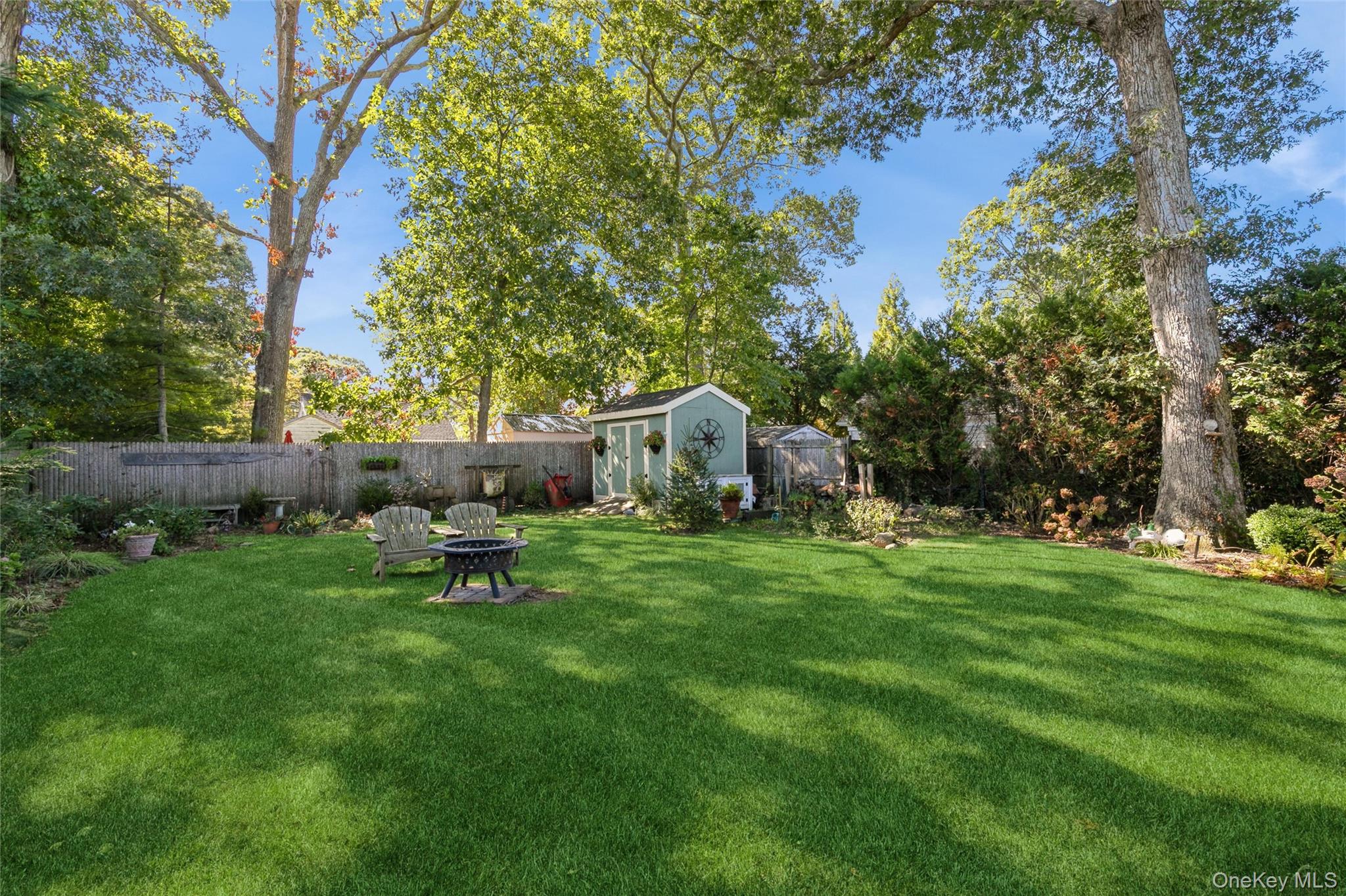 240 Wicks Road New Suffolk, NY 11956 - Photo 28 of 36 a garden with wooden fence