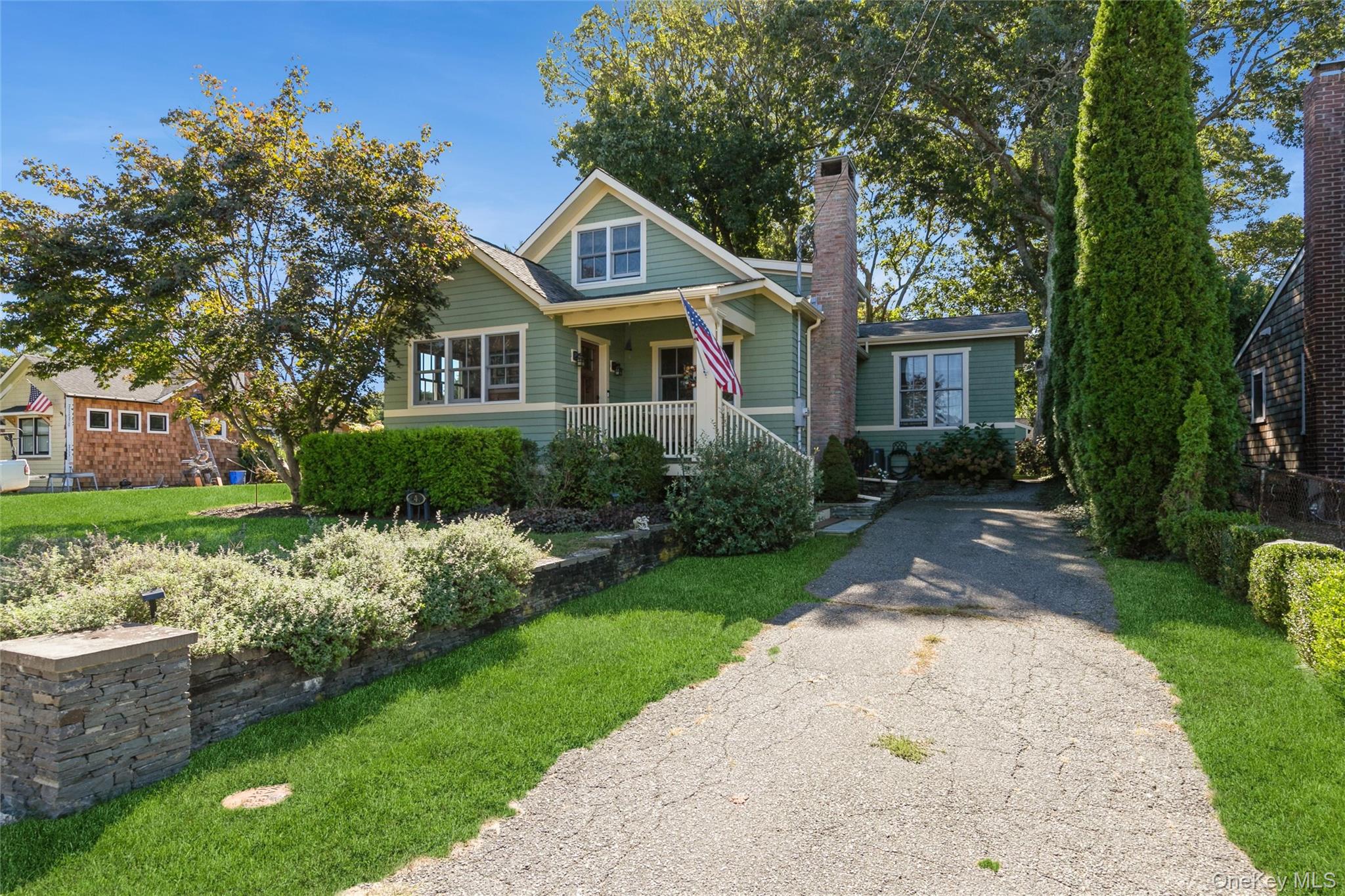 240 Wicks Road New Suffolk, NY 11956 - Photo 3 of 36 a front view of a house with garden