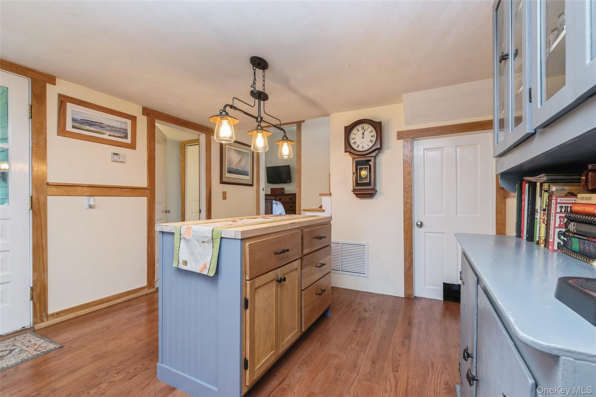 240 Wicks Road New Suffolk, NY 11956 - Photo 10 of 36 a kitchen with a refrigerator and wooden floor