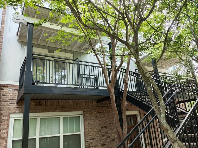 a view of a house with a small deck