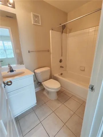 a spacious bedroom with a bed and a dresser