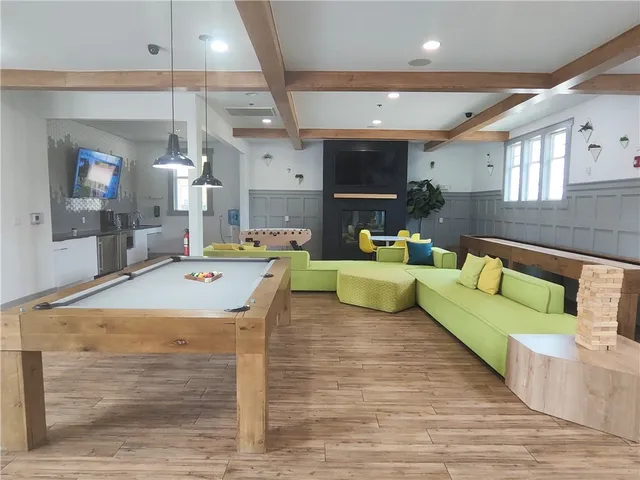 a room with gym equipment and large windows