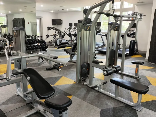 a kitchen with stainless steel appliances kitchen island granite countertop a sink and cabinets