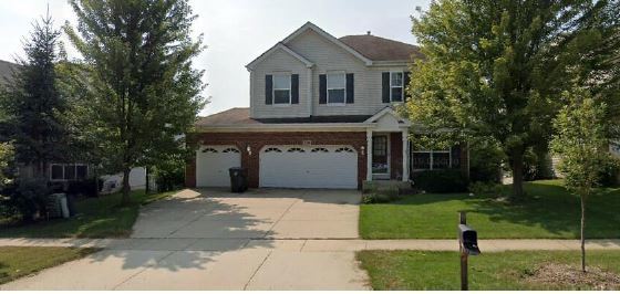 318 Emerald Drive Streamwood, IL 60107 - Photo 19 of 19 a front view of a house with a garden and yard