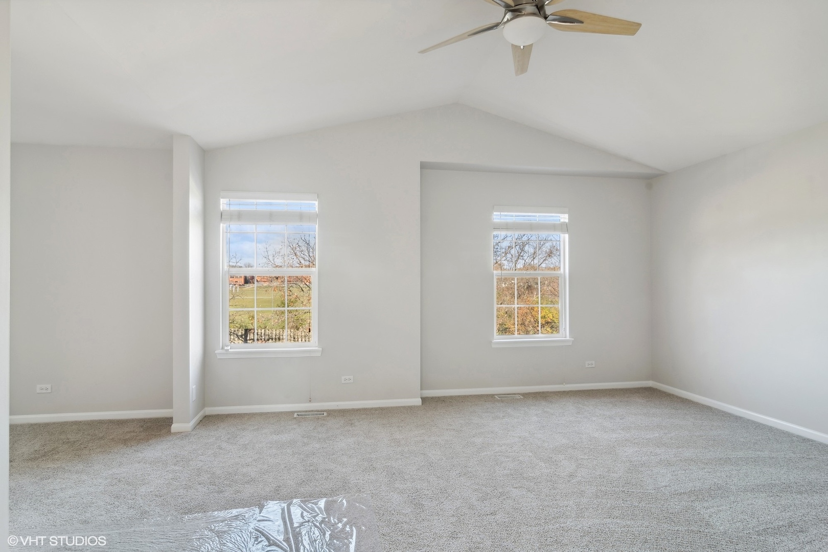 318 Emerald Drive Streamwood, IL 60107 - Photo 7 of 19 an empty room with windows and fan