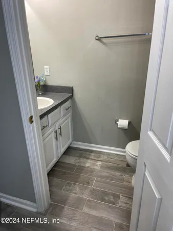 a bathroom with a granite countertop sink toilet and a shower