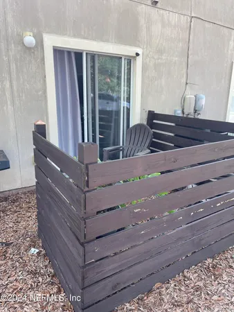 a bedroom with a bed next to a window with a flat tv screen on dresser