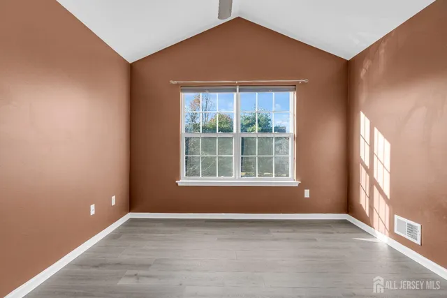 a view of an empty room with a window