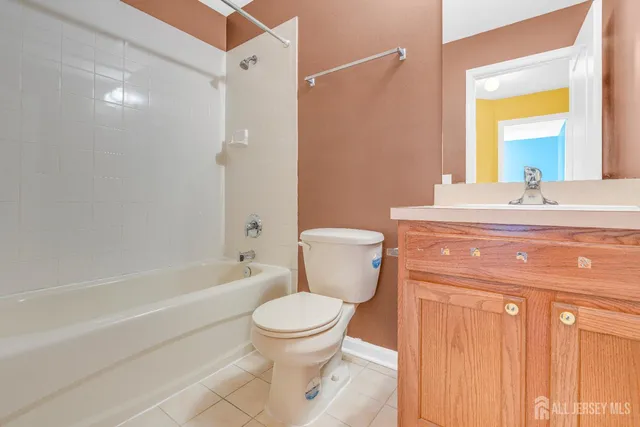 a bathroom with a granite countertop toilet sink and shower