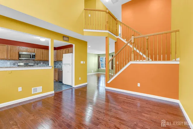 a view of a kitchen with furniture and wooden floor