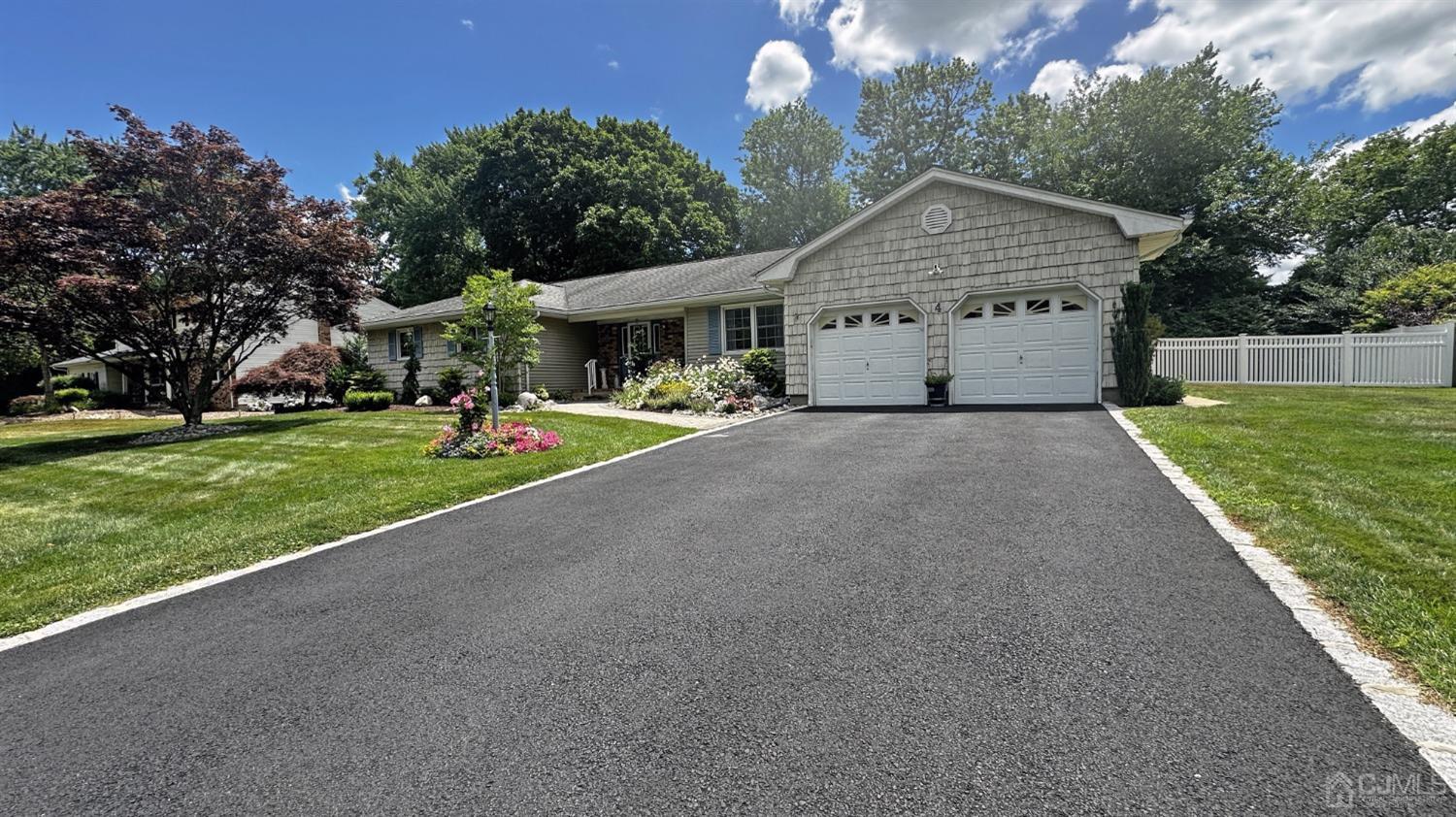 a view of a house with a yard and potted plants