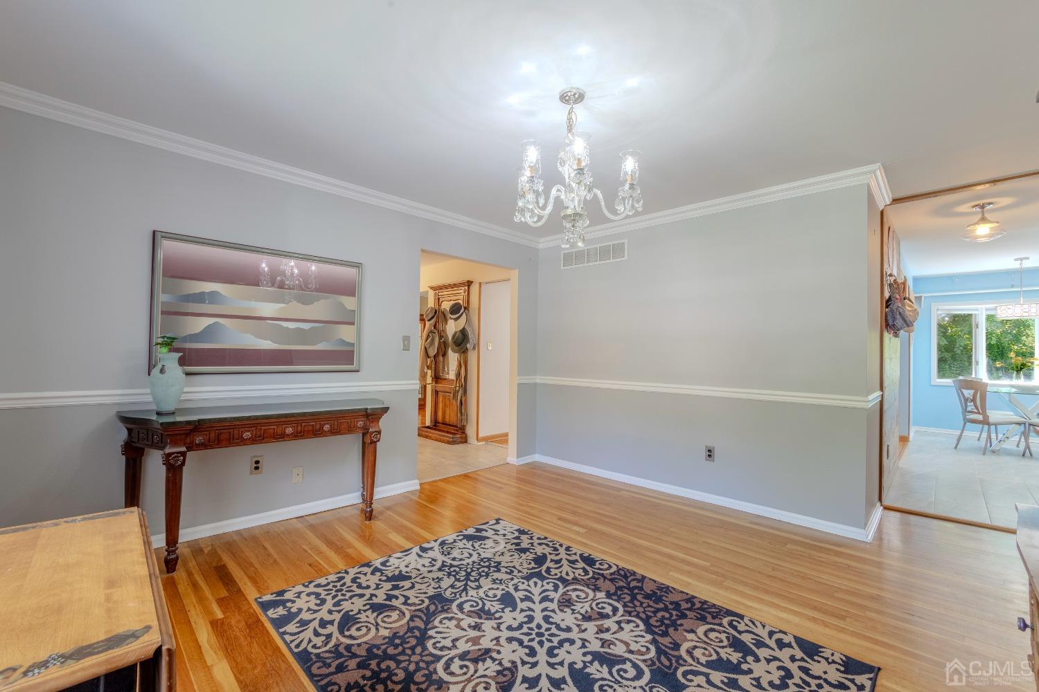 4 Putnam Road East Brunswick, NJ 08816 - Photo 12 of 53 a room with chandelier and wooden floor
