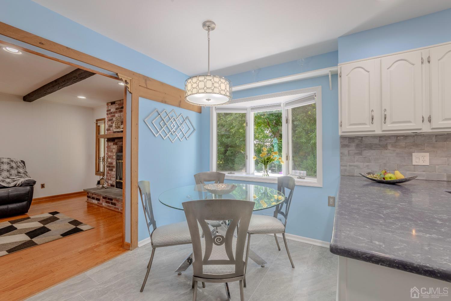 4 Putnam Road East Brunswick, NJ 08816 - Photo 14 of 53 a view of a dining room with furniture a chandelier and wooden floor
