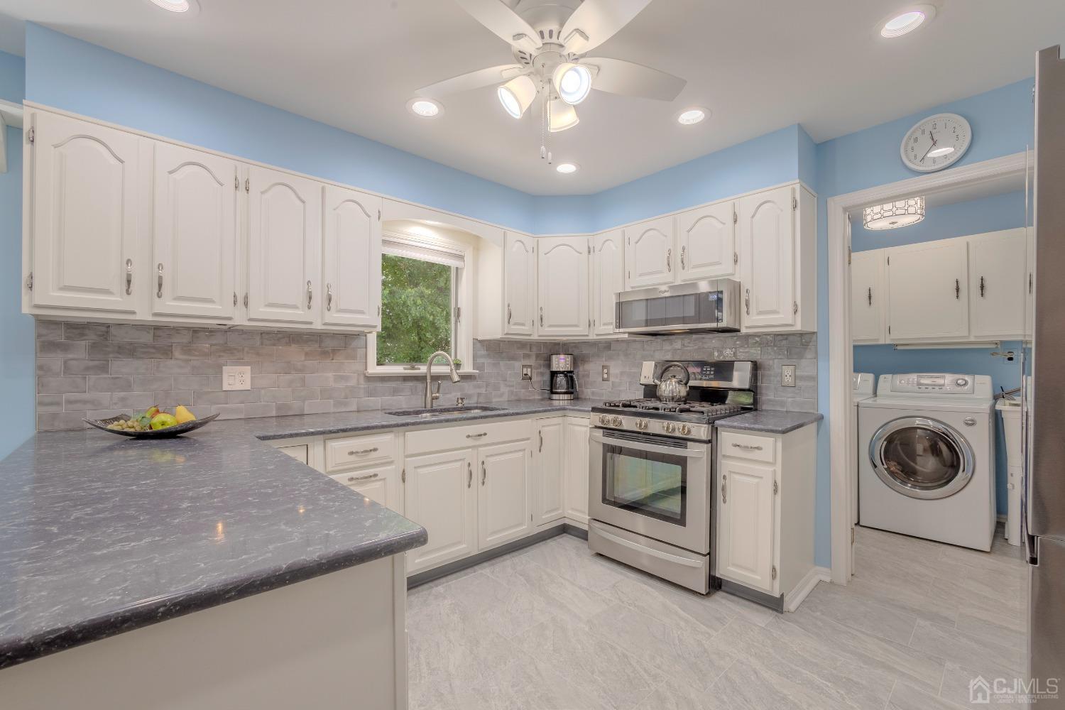 4 Putnam Road East Brunswick, NJ 08816 - Photo 15 of 53 a kitchen with stainless steel appliances granite countertop a sink and a stove