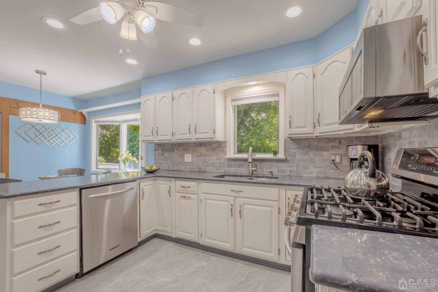 4 Putnam Road East Brunswick, NJ 08816 - Photo 16 of 53 a kitchen with stainless steel appliances a sink stove and cabinets
