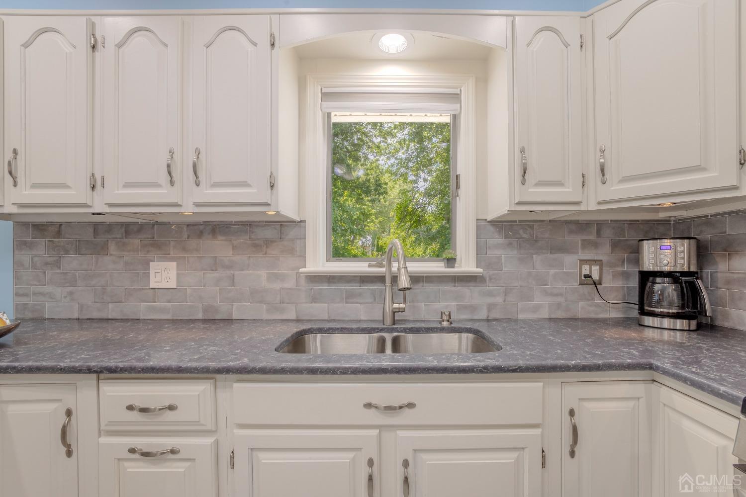 4 Putnam Road East Brunswick, NJ 08816 - Photo 17 of 53 a kitchen with granite countertop a sink and a window