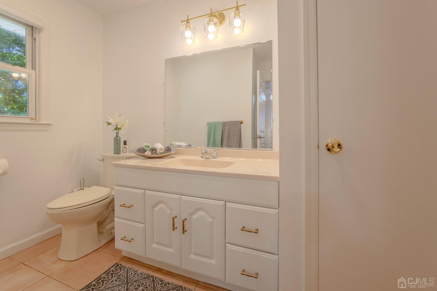 4 Putnam Road East Brunswick, NJ 08816 - Photo 35 of 53 a bathroom with a sink toilet and vanity