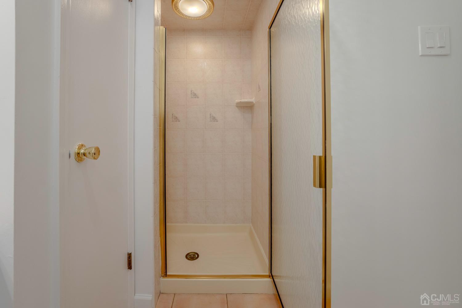 4 Putnam Road East Brunswick, NJ 08816 - Photo 36 of 53 a bathroom with a glass shower door