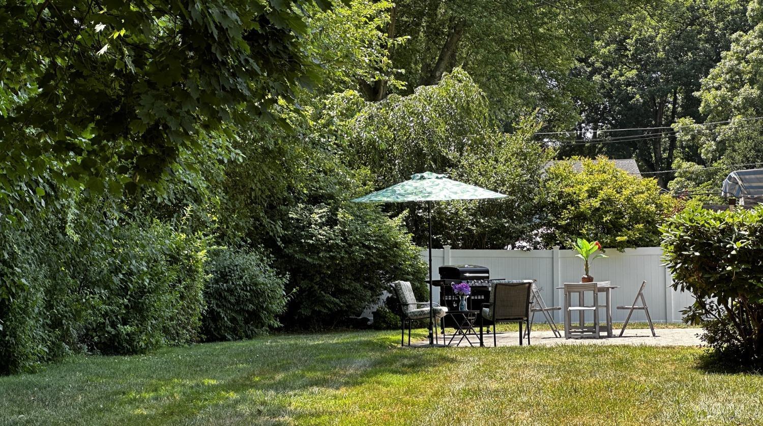 4 Putnam Road East Brunswick, NJ 08816 - Photo 44 of 53 a view of a table and chairs under an umbrella