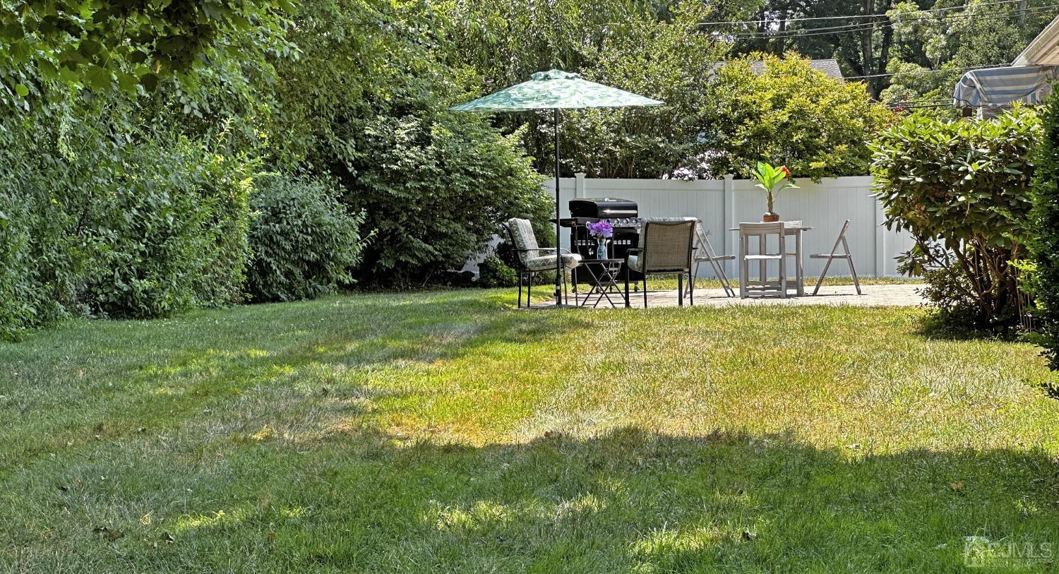 4 Putnam Road East Brunswick, NJ 08816 - Photo 46 of 53 a view of a backyard with table and chairs under an umbrella