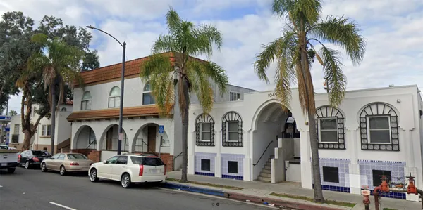 a couple of cars parked in front of a building