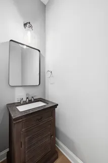 a bathroom with a shower sink and mirror