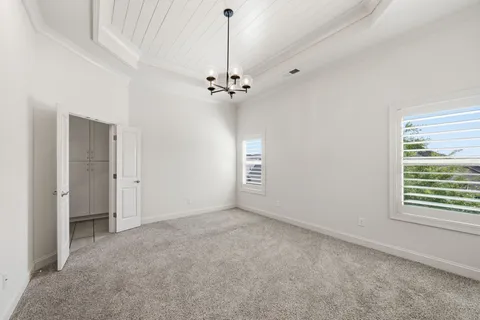 a spacious bathroom with a granite countertop double vanity sink a mirror and a toilet