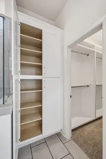 a view of an empty room with cabinets and wooden floor