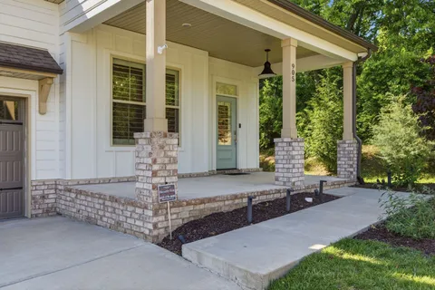 a view of a livingroom with wooden floor and stairs