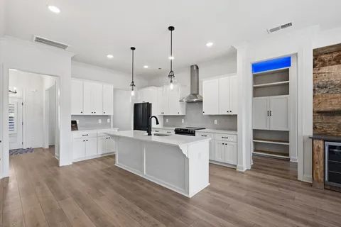 a close view of a stove top oven and cabinets