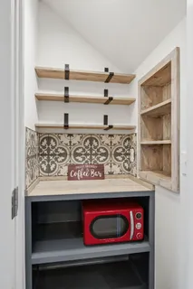 a view of main area fire place refrigerator and window